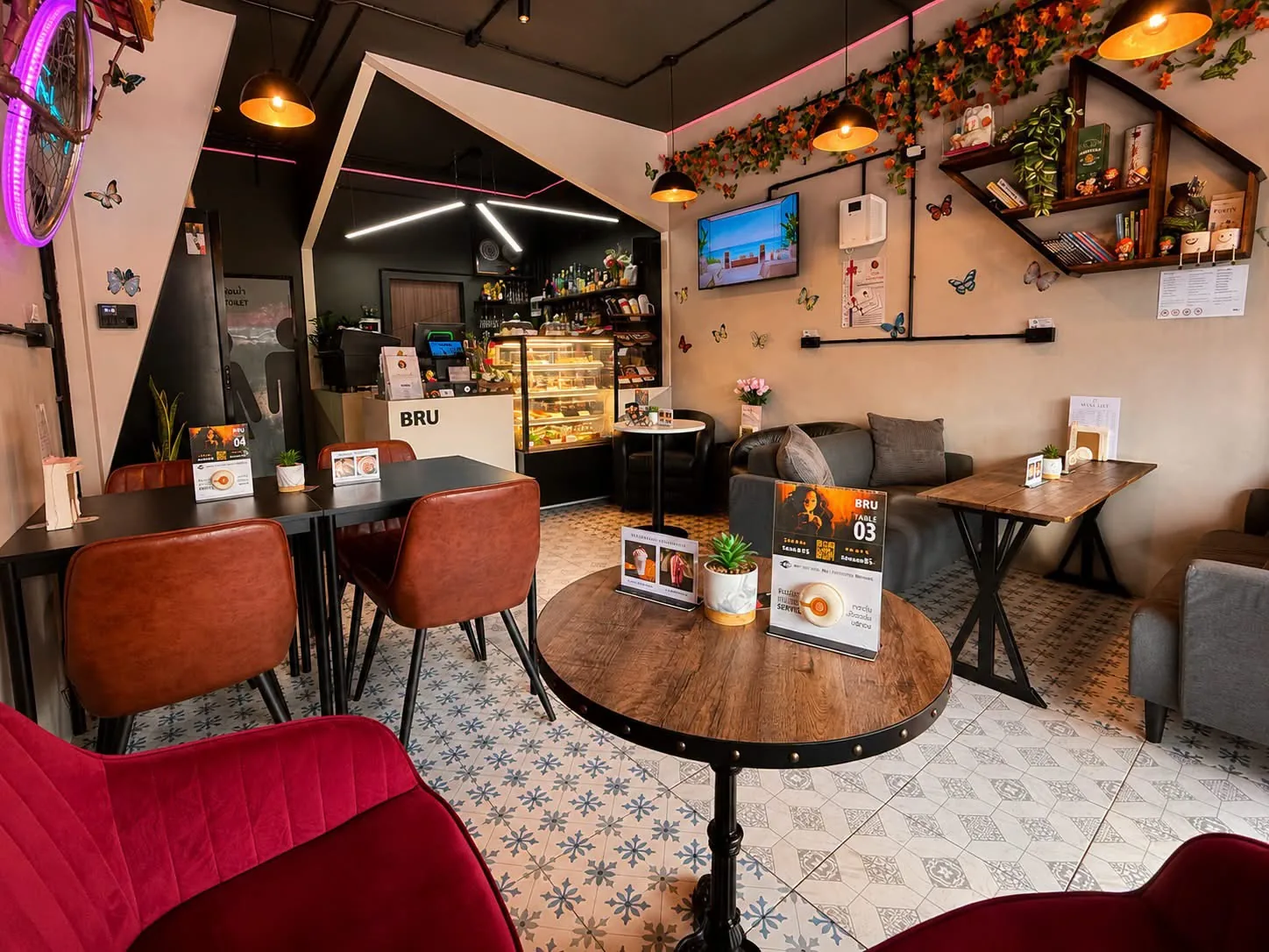 BRU Pattaya lounge with leather chairs, tables and neon decor